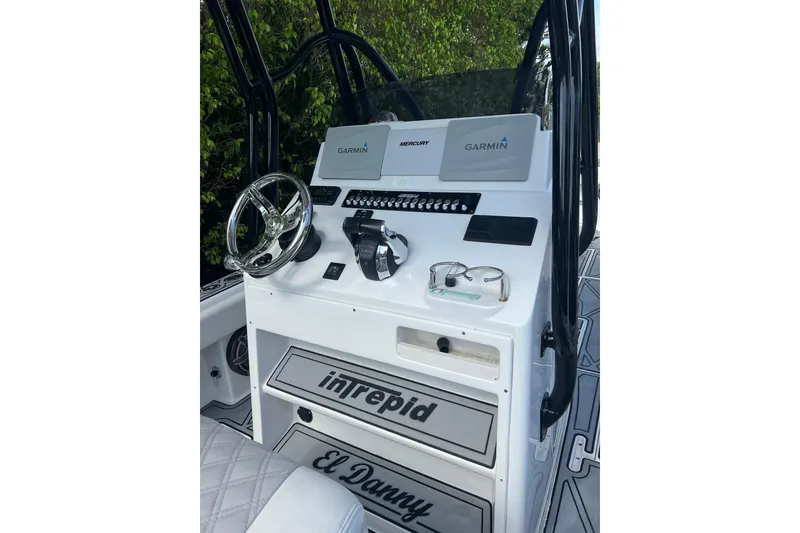 Slide: The Image of 1990 Intrepid 28 Open boat dashboard with Garmin navigation and Mercury controls. - 7