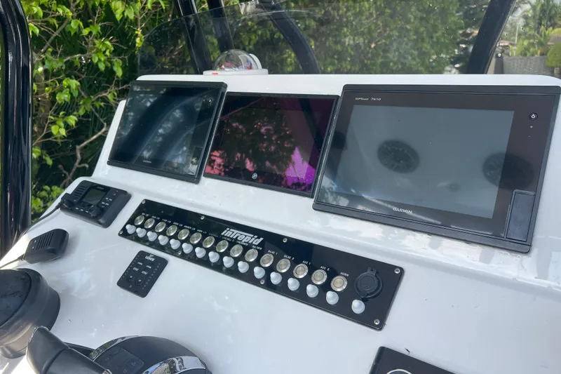 Slide: The Image of Control panel of a 1990 Intrepid 28 Open boat with Garmin displays. - 9