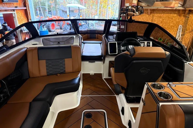 Slide: The Image of 2022 Malibu Wakesetter 25 LSV interior with luxurious seating and modern dashboard. - 14
