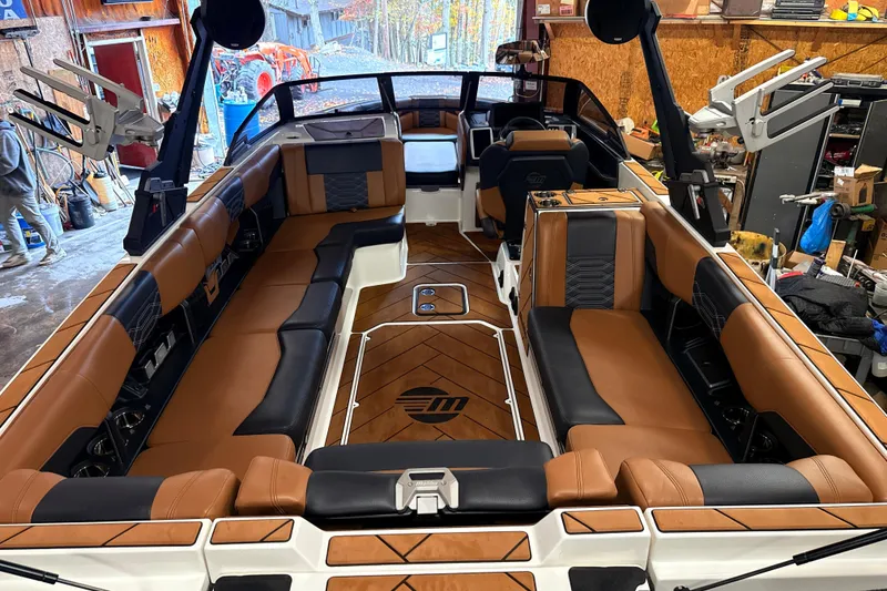 Slide: The Image of 2022 Malibu Wakesetter 25 LSV interior with luxurious brown and black seating. - 15