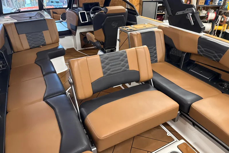 Slide: The Image of Luxurious interior of 2022 Malibu Wakesetter 25 LSV with tan and black seating. - 21