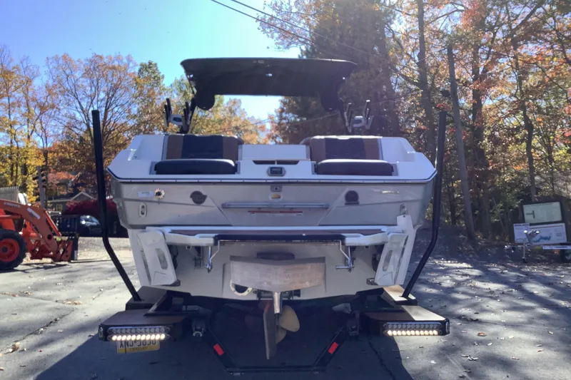 Slide: The Image of 2022 Malibu Wakesetter 25 LSV boat, rear view, parked outdoors in autumn setting. - 3