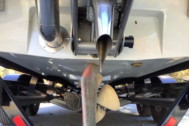 Slide: The Image of 2022 Malibu Wakesetter 25 LSV boat underside showing propeller and exhaust system. - 4