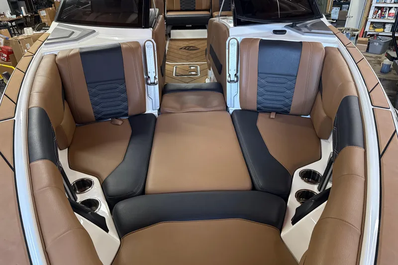 Slide: The Image of 2022 Malibu Wakesetter 25 LSV interior with brown and black seating, cup holders, and luxurious design. - 9