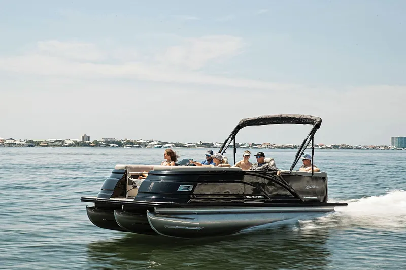 Slide: The Image of 2022 Blue Wave Pontoon boat at Thunder Marine dealership, featuring sleek design and canopy. - 1