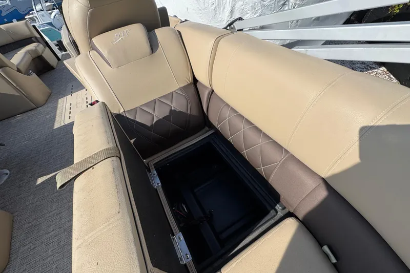 Slide: The Image of 2022 Blue Wave Pontoon interior storage compartment with open door and visible bag. - 11