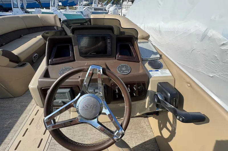Slide: The Image of 2022 Blue Wave Pontoon boat dashboard with steering wheel and control panel. - 12