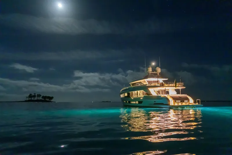 Slide: The Image of Luxurious 2023 Horizon FD90 yacht illuminated at night under a moonlit sky. - 23