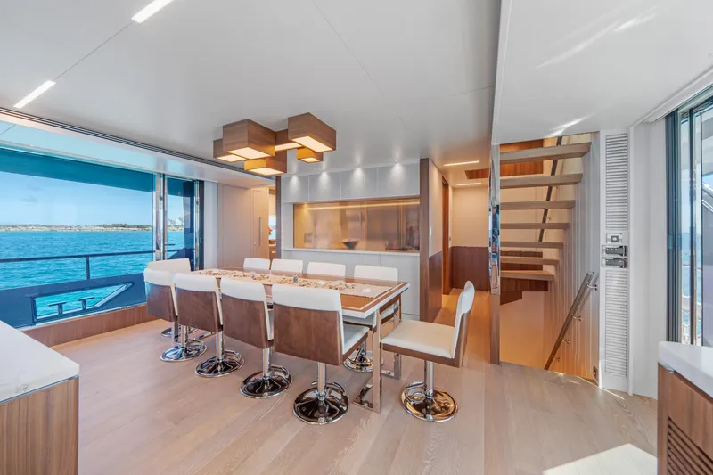 Slide: The Image of Luxurious dining area on 2023 Horizon FD90 yacht with ocean view and modern decor. - 13