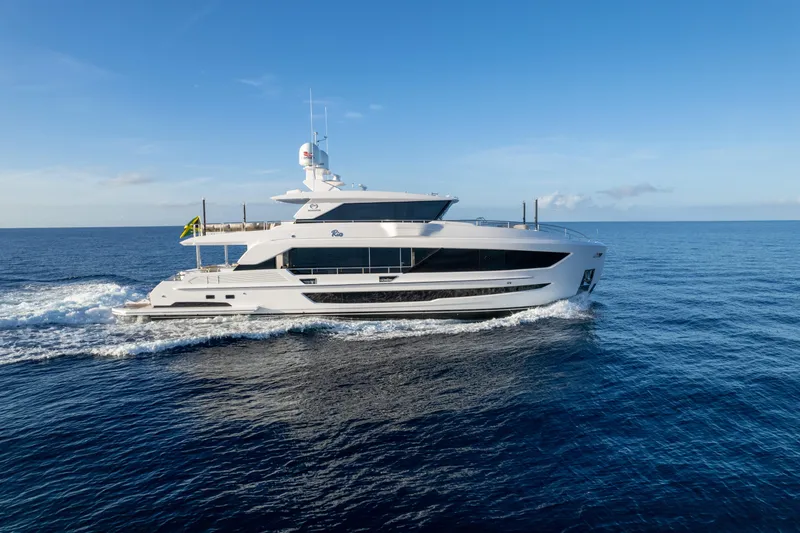 Slide: The Image of Luxurious 2023 Horizon FD90 yacht cruising on open sea under clear blue sky. - 30