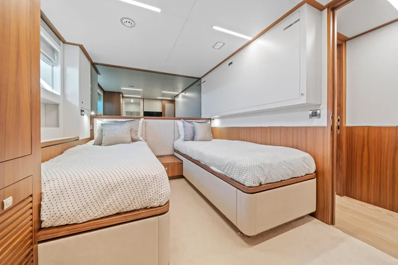 Slide: The Image of Luxurious twin bedroom in 2023 Horizon FD90 yacht with modern wood accents. - 21