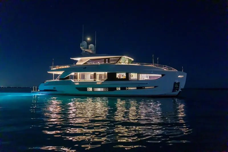 The Image of Luxurious 2023 Horizon FD90 yacht illuminated at night on calm waters. - 0