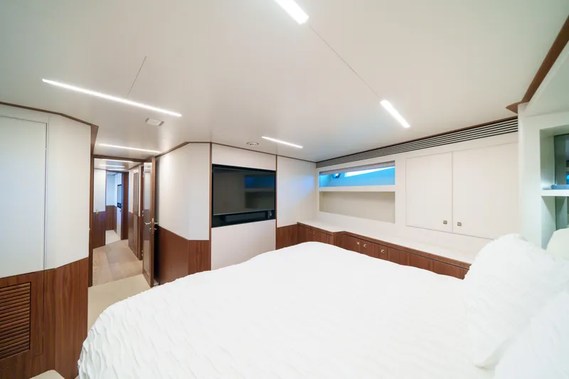 Slide: The Image of Luxurious interior of 2023 Horizon FD90 yacht bedroom with modern design and wood accents. - 20