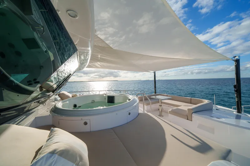 Slide: The Image of Luxurious Horizon FD90 yacht deck with jacuzzi, seating, and ocean view, 2023 model. - 31