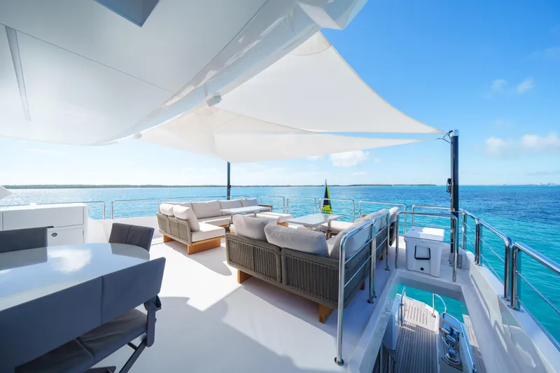 Slide: The Image of Luxurious Horizon FD90 yacht deck with ocean view, featuring elegant seating and shade canopy, 2023 model. - 27
