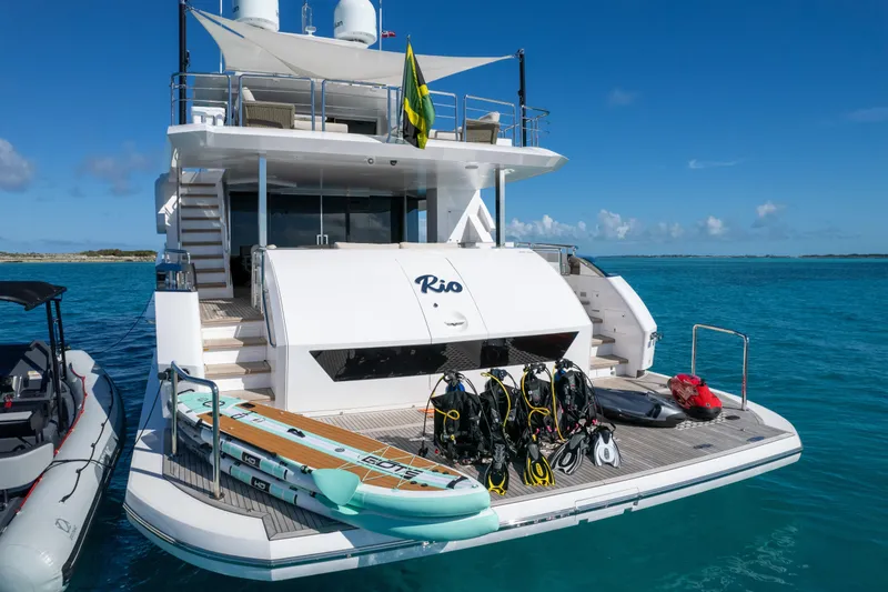 Slide: The Image of Luxury Horizon FD90 yacht with water sports gear, anchored in clear blue sea, 2023 model. - 35