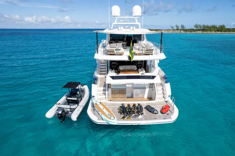 Slide: The Image of Luxurious Horizon FD90 yacht in turquoise waters, equipped with water sports gear, 2023 model. - 34