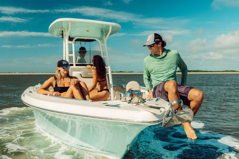 Slide: The Image of Manufacturer Provided Image: 2025 Key West 239 FS boat in shallow water with two people, lighthouse in background. - 11