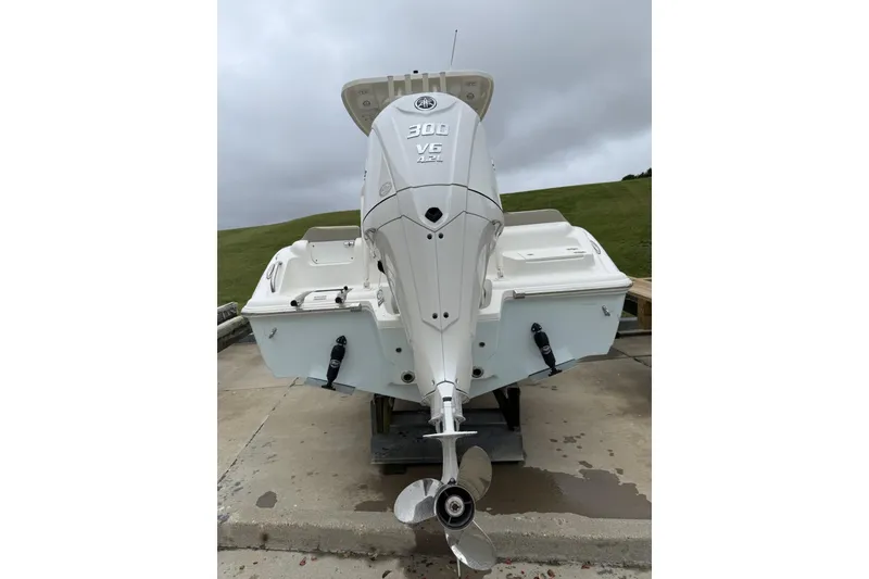 Slide: The Image of 2026 Key West 239 FS boat with Yamaha engine, displayed outdoors near a building. - 2