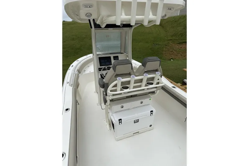 Slide: The Image of 2026 Key West 239 FS boat with powerful outboard motor, docked on concrete surface. - 3