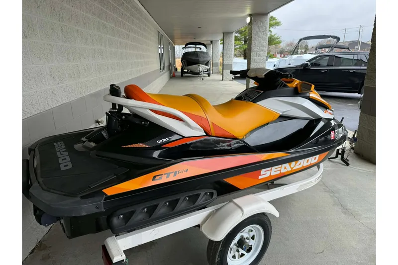 Slide: The Image of 2018 Seadoo GTI SE 155 jet ski on trailer, black and orange design. - 10