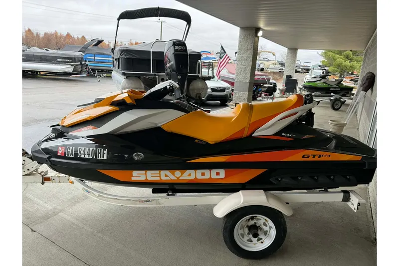 Slide: The Image of 2018 Seadoo GTI SE 155 jet ski on trailer, orange and black design. - 9