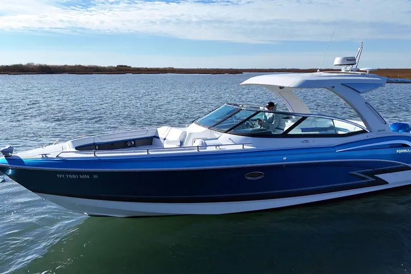 Slide: The Image of 2019 Formula 350 Crossover Bowrider OB cruising on a calm lake. - 11