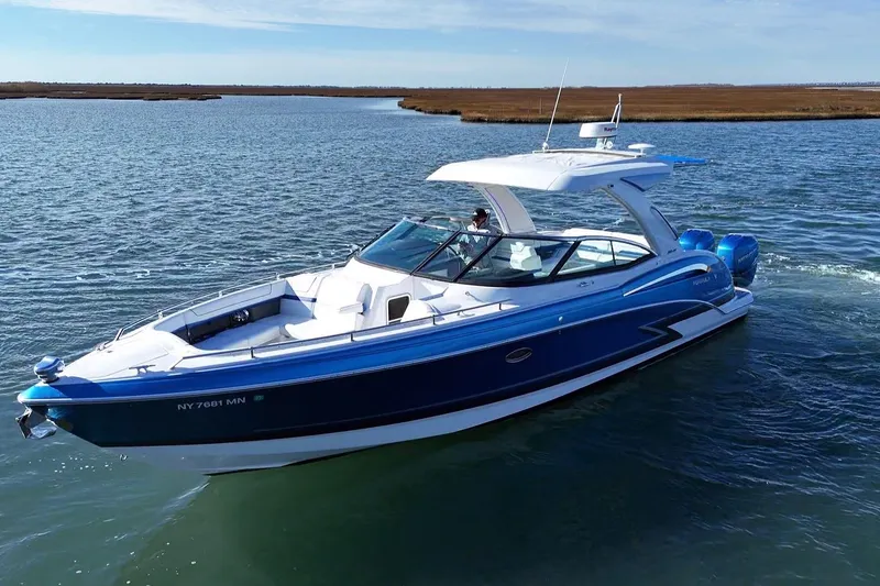 Slide: The Image of 2019 Formula 350 Crossover Bowrider OB cruising on a serene waterway. - 12