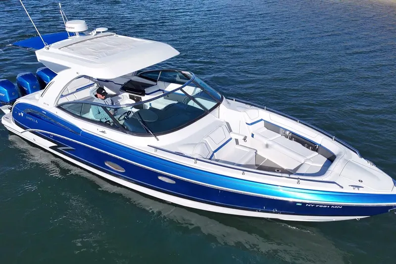 Slide: The Image of 2019 Formula 350 Crossover Bowrider OB on water, featuring sleek blue and white design. - 16