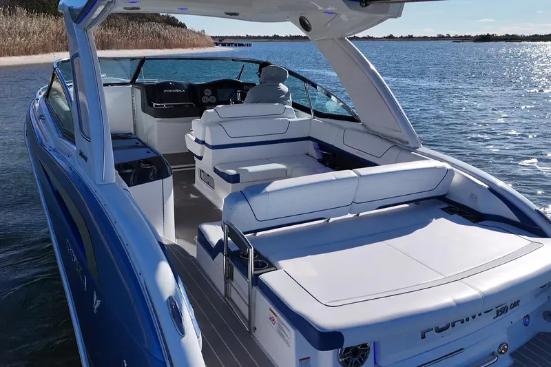 Slide: The Image of 2019 Formula 350 Crossover Bowrider OB on serene water, showcasing luxurious seating and sleek design. - 24