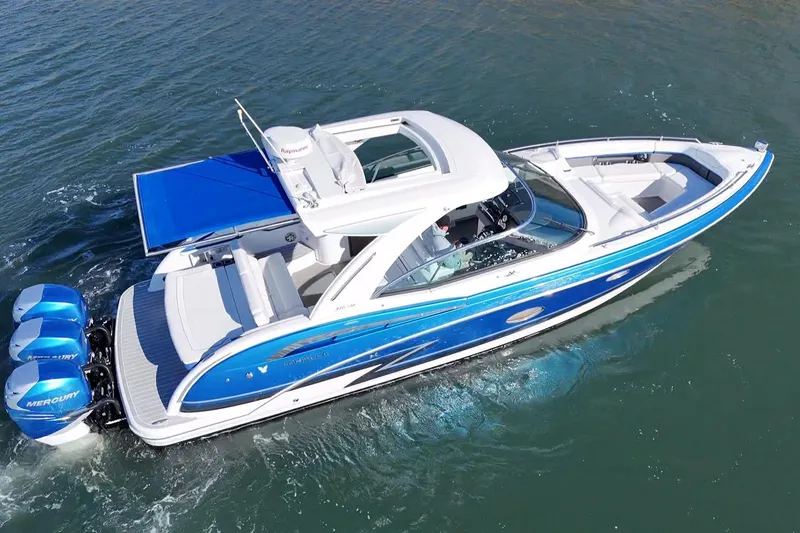 Slide: The Image of 2019 Formula 350 Crossover Bowrider OB cruising on water, featuring blue and white design. - 30