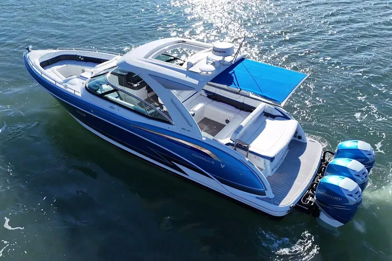 Slide: The Image of 2019 Formula 350 Crossover Bowrider OB on water, featuring triple Mercury outboards. - 32