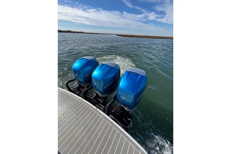 Slide: The Image of 2019 Formula 350 Crossover Bowrider OB with triple blue outboard motors on water. - 33