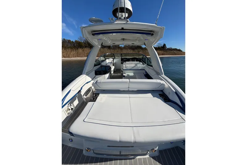 Slide: The Image of 2019 Formula 350 Crossover Bowrider OB on water, showcasing spacious seating and sleek design. - 35