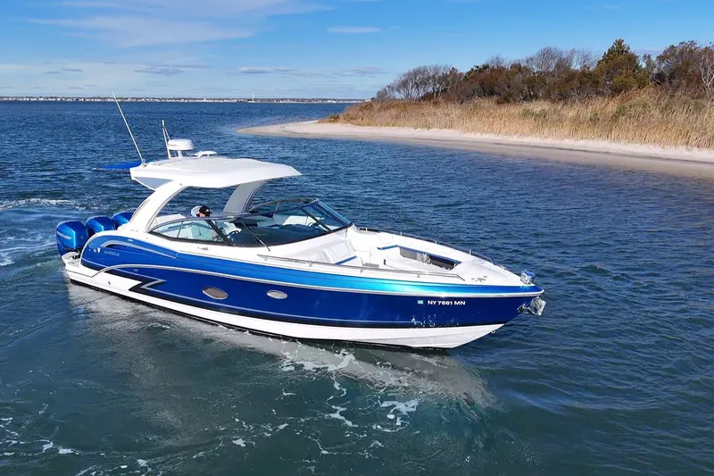 Slide: The Image of 2019 Formula 350 Crossover Bowrider OB cruising near a sandy shoreline. - 4