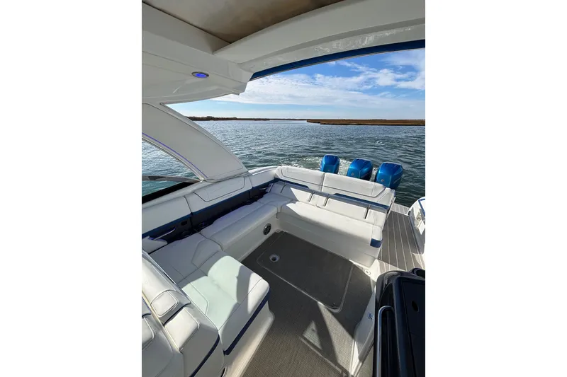Slide: The Image of 2019 Formula 350 Crossover Bowrider OB on water, showcasing spacious seating and triple outboard engines. - 42