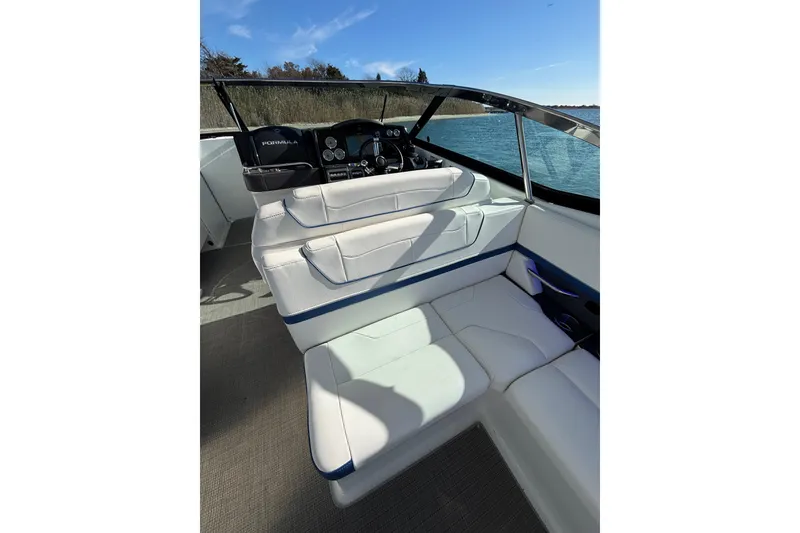 Slide: The Image of 2019 Formula 350 Crossover Bowrider OB interior with white seating and dashboard view. - 43
