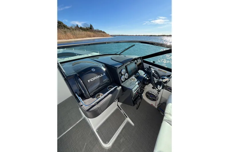 Slide: The Image of 2019 Formula 350 Crossover Bowrider OB cockpit with steering wheel and controls, on a sunny day. - 46