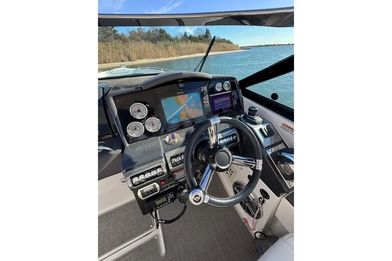 Slide: The Image of 2019 Formula 350 Crossover Bowrider OB helm with navigation display and controls. - 50