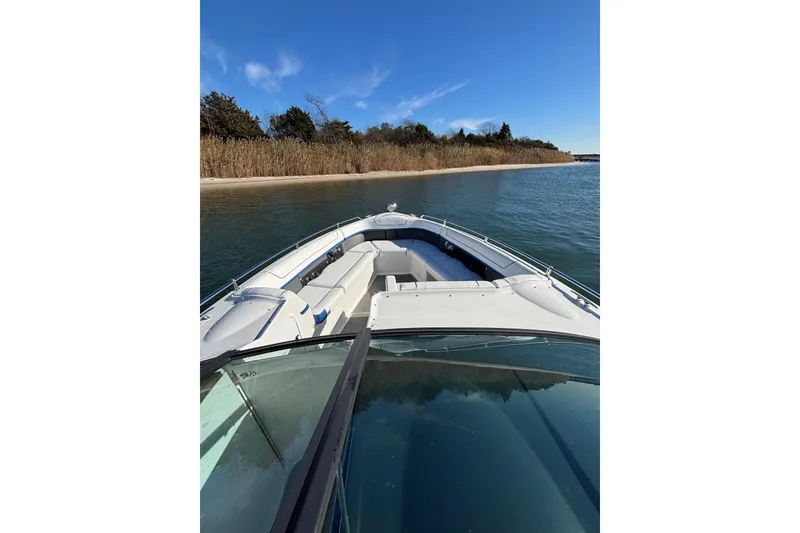 Slide: The Image of 2019 Formula 350 Crossover Bowrider OB cruising near a scenic shoreline. - 56