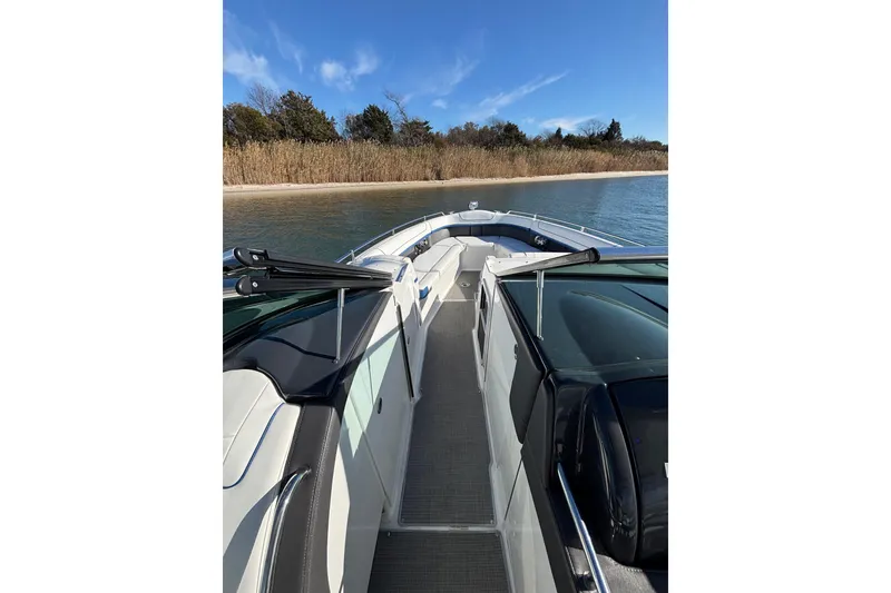 Slide: The Image of 2019 Formula 350 Crossover Bowrider OB on calm water near a sandy shore. - 57