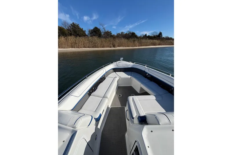 Slide: The Image of 2019 Formula 350 Crossover Bowrider OB on calm water near a sandy shore. - 58