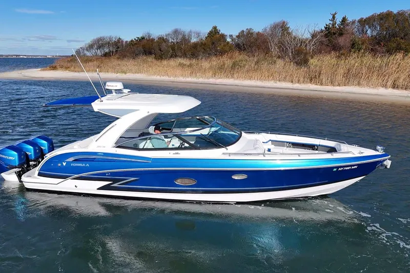 Slide: The Image of 2019 Formula 350 Crossover Bowrider OB cruising near a sandy shoreline. - 6