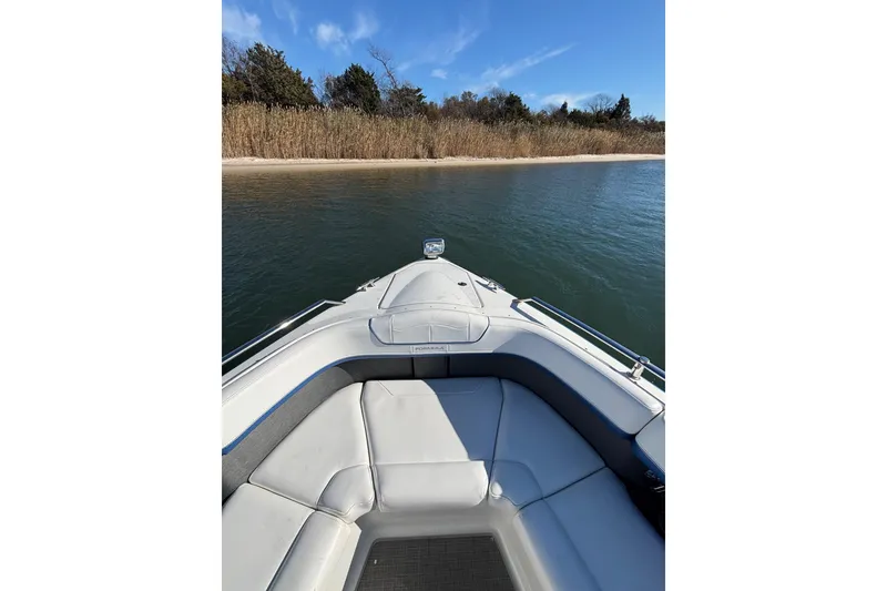Slide: The Image of 2019 Formula 350 Crossover Bowrider OB on calm water near a sandy shore. - 61