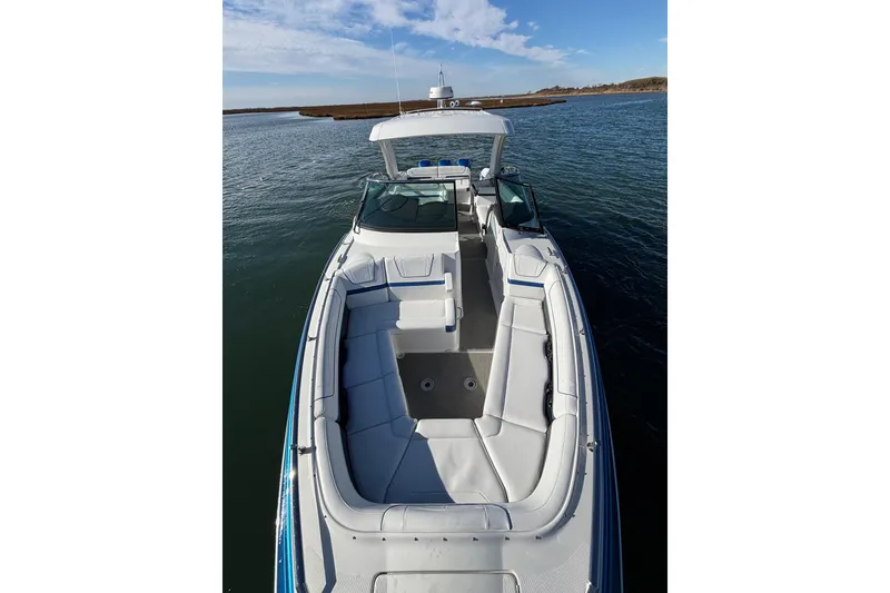 Slide: The Image of 2019 Formula 350 Crossover Bowrider OB on calm water, showcasing spacious seating. - 62