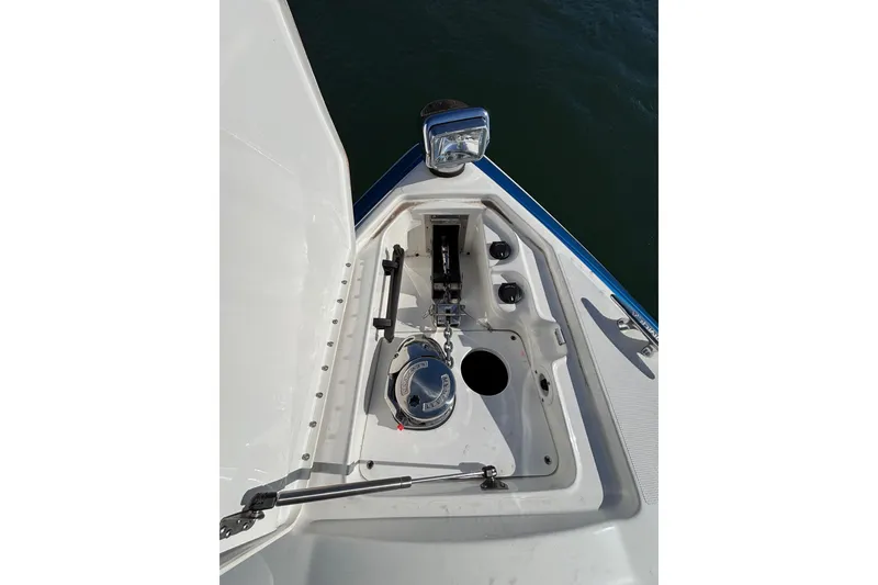 Slide: The Image of 2019 Formula 350 Crossover Bowrider OB anchor compartment with winch and chain. - 64