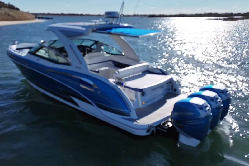 Slide: The Image of 2019 Formula 350 Crossover Bowrider OB on water, featuring sleek blue design and powerful outboard engines. - 7