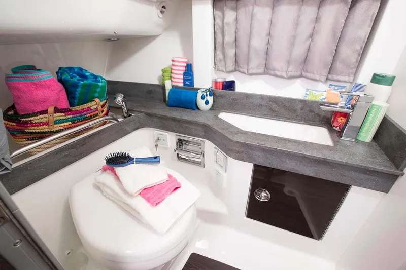 Slide: The Image of Manufacturer Provided Image: 2019 Formula 350 Crossover Bowrider OB bathroom with modern amenities and colorful towels. - 73