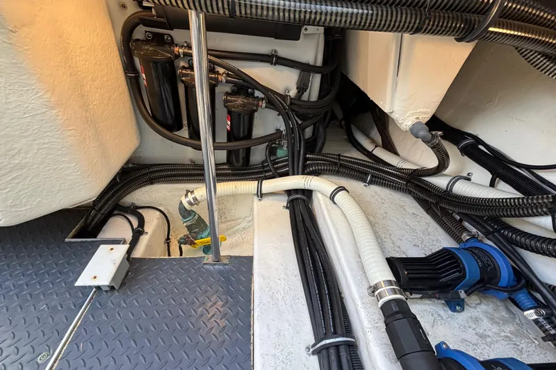 Slide: The Image of Engine compartment of a 2019 Formula 350 Crossover Bowrider OB with visible wiring and components. - 79