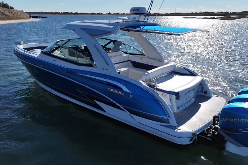 Slide: The Image of 2019 Formula 350 Crossover Bowrider OB on water, featuring sleek blue design and powerful engines. - 8